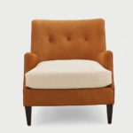Cognac Charm Armchair – cognac-hued upholstered chair with button-tufted back and plush bouclé seat cushion