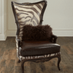 Teak Safari Armchair – solid teak frame with zebra-print leather and brass nailhead trim