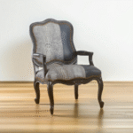 Majestic Teak Chair – hand-carved teak frame with grey crocodile-embossed leather and brass stud detailing
